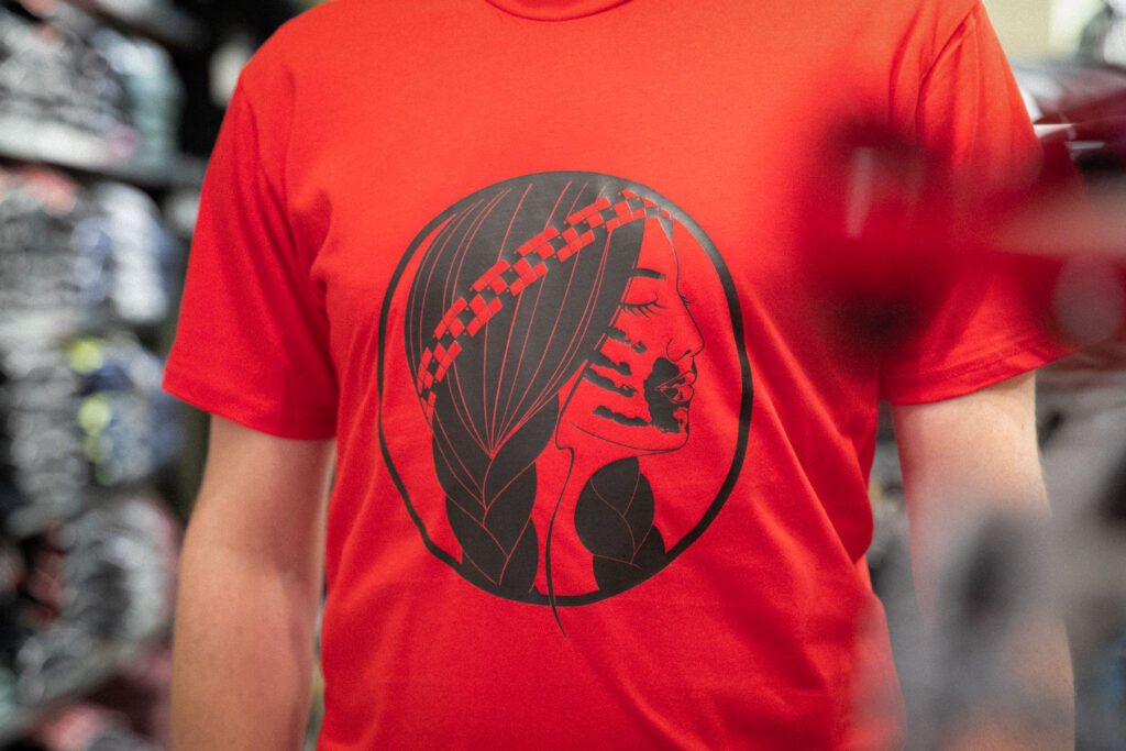 Close-up of red shirt with new design honouring Missing and Murdered Indigenous Women, Girls and Two Spirit People