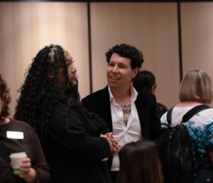 Indigenous entrepreneur Darion Ducharme, in conversation with woman at launch event.