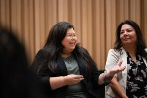 Amy Jackson, director of Mittohnee Pogo’ohtah, in conversation with woman attending launch event.