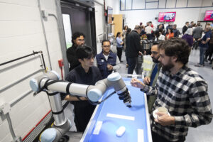 Male researcher demonstrates manufacturing processes at RRC Polytech's Centre for Automation and Manufacturing Technology Transfer.