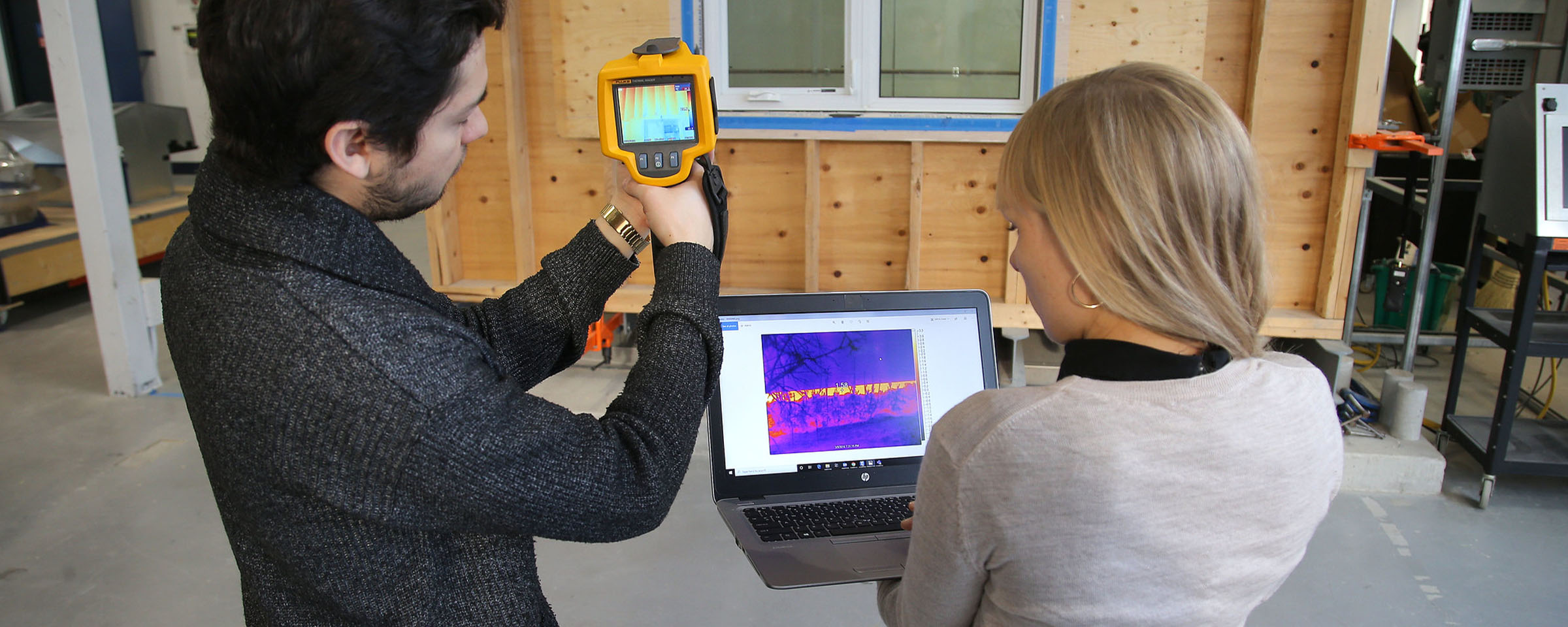 Building science professionals reading measurements with FLUKE equipment