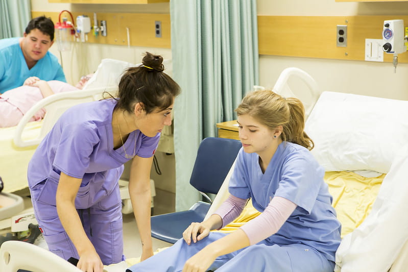 women helping patient