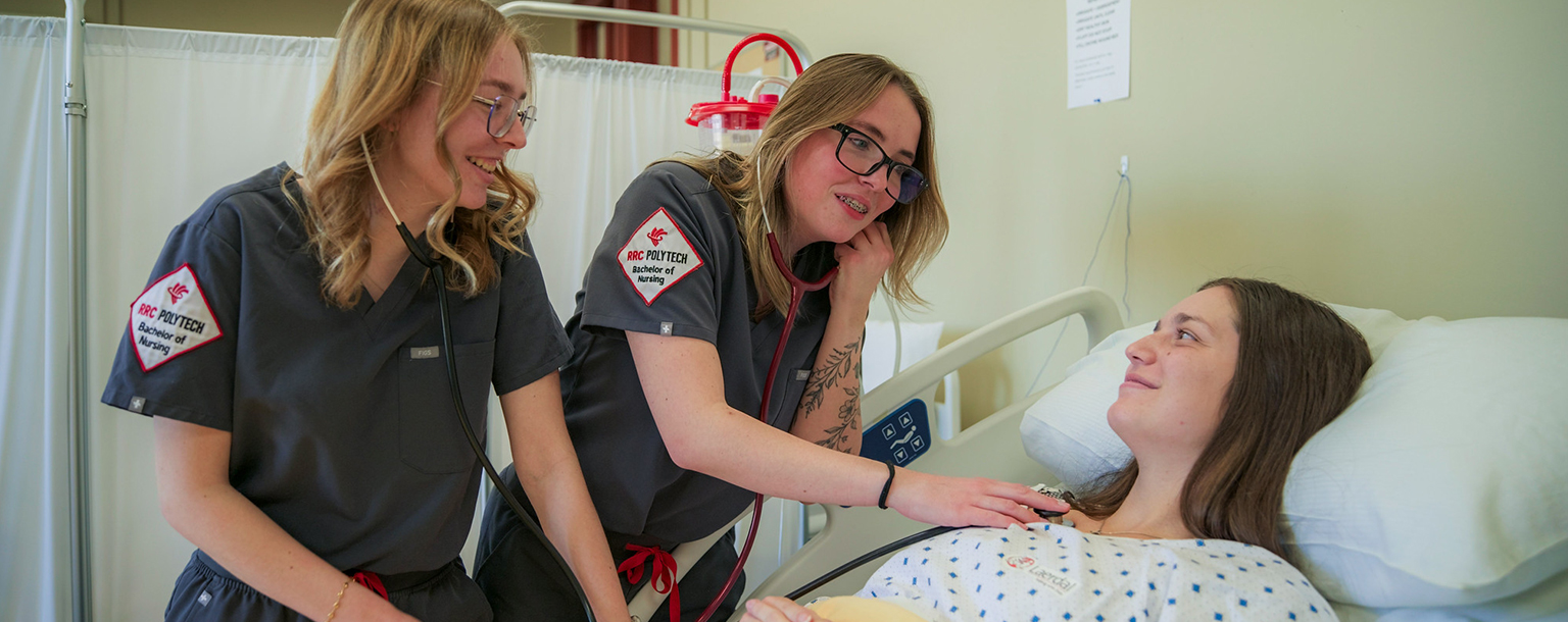 two health students with patient