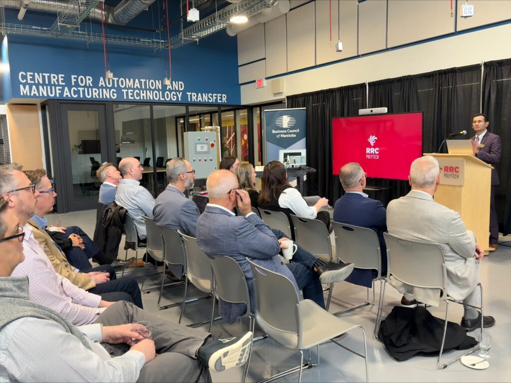 a presenter at a podium speaking to an audience of business leaders