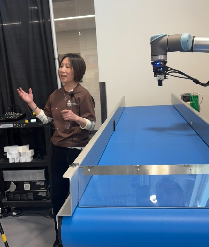 a person demonstrates a robotic arm 