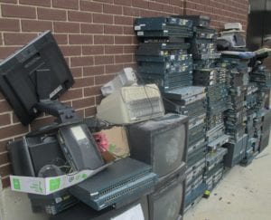 Piles of electronic waste ready to be picked up for recycling.