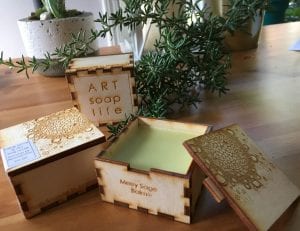 Wooden box which says "Art Soap Life" on the top and open wooden box filled withMerry Sage Balm"