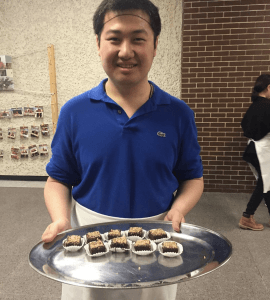 An ACC student handing out fair trade brownies for Fair Trade Campus Week.