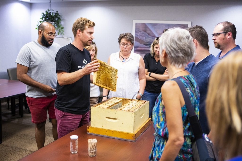 Chris Kirouac, Beeproject Apiaries, holds up a honeycomb in a demonstration at Red River College Polytechnic