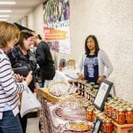 Women selling jarred preserves to market goers