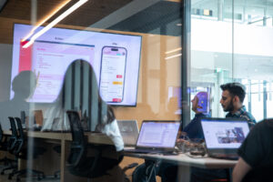 Students in a lab looking at screenshots of an app