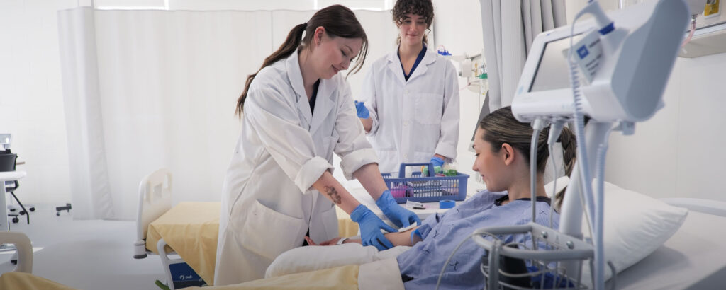 Nursing students work on a patient in a Simulation Centre.