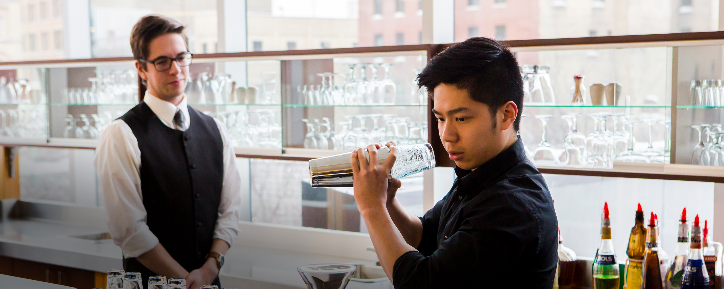 Student mixing a drink in a mixology lab