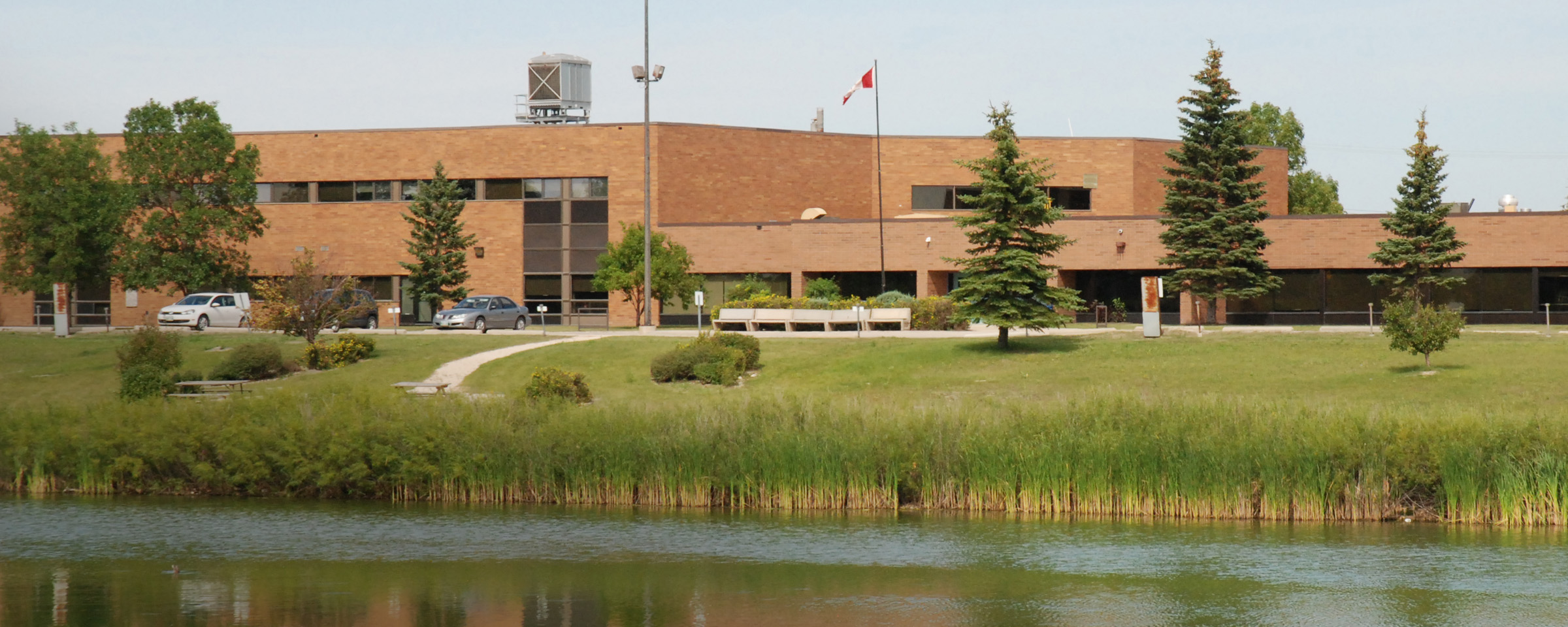 Exterior of building with pond in front