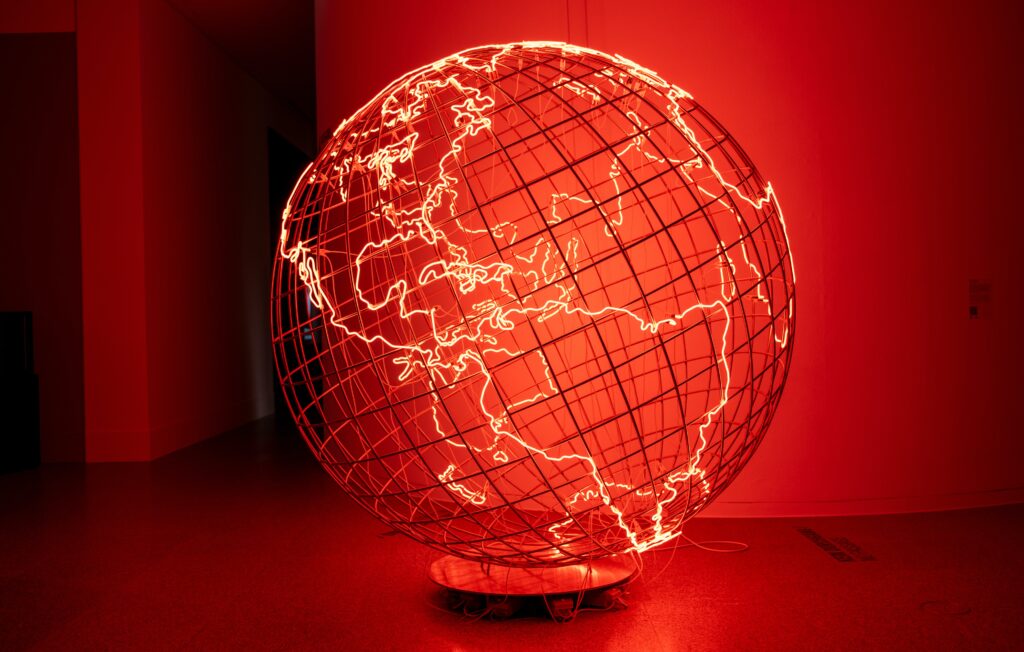 A stylized image of a globe lit with a red backdrop