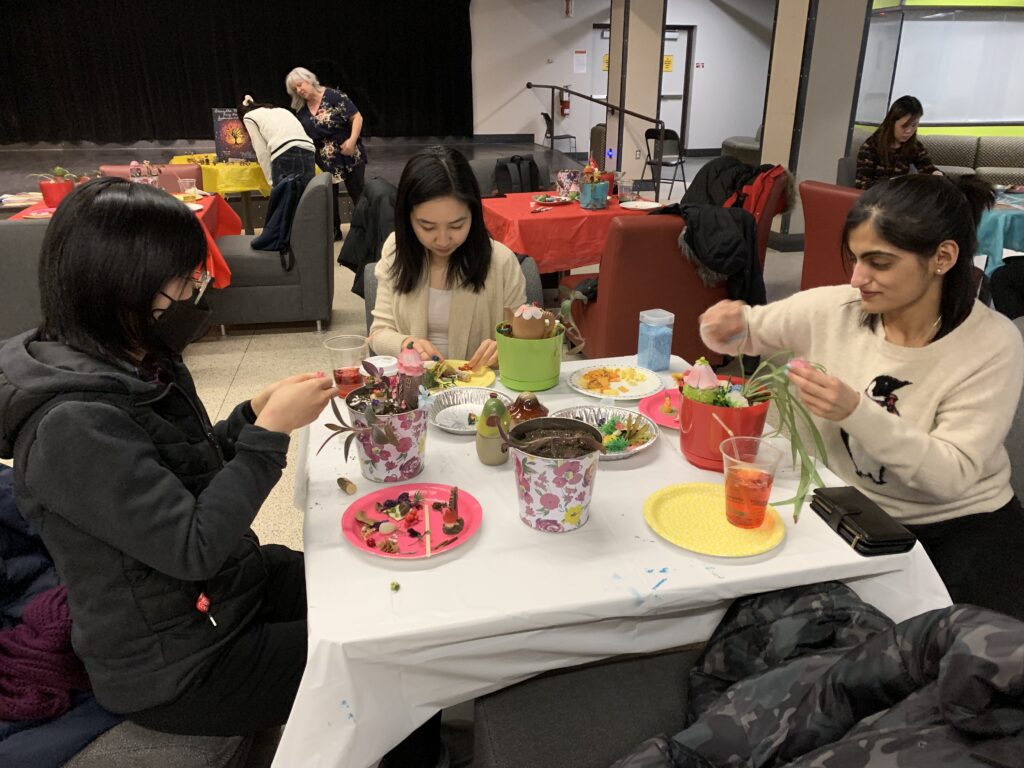Group of three participants making fairy gardens.