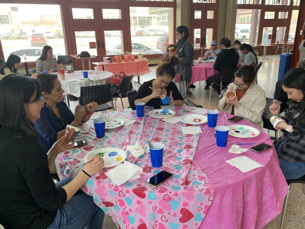 Group of students painting plant pots at the Exchange District Campus.