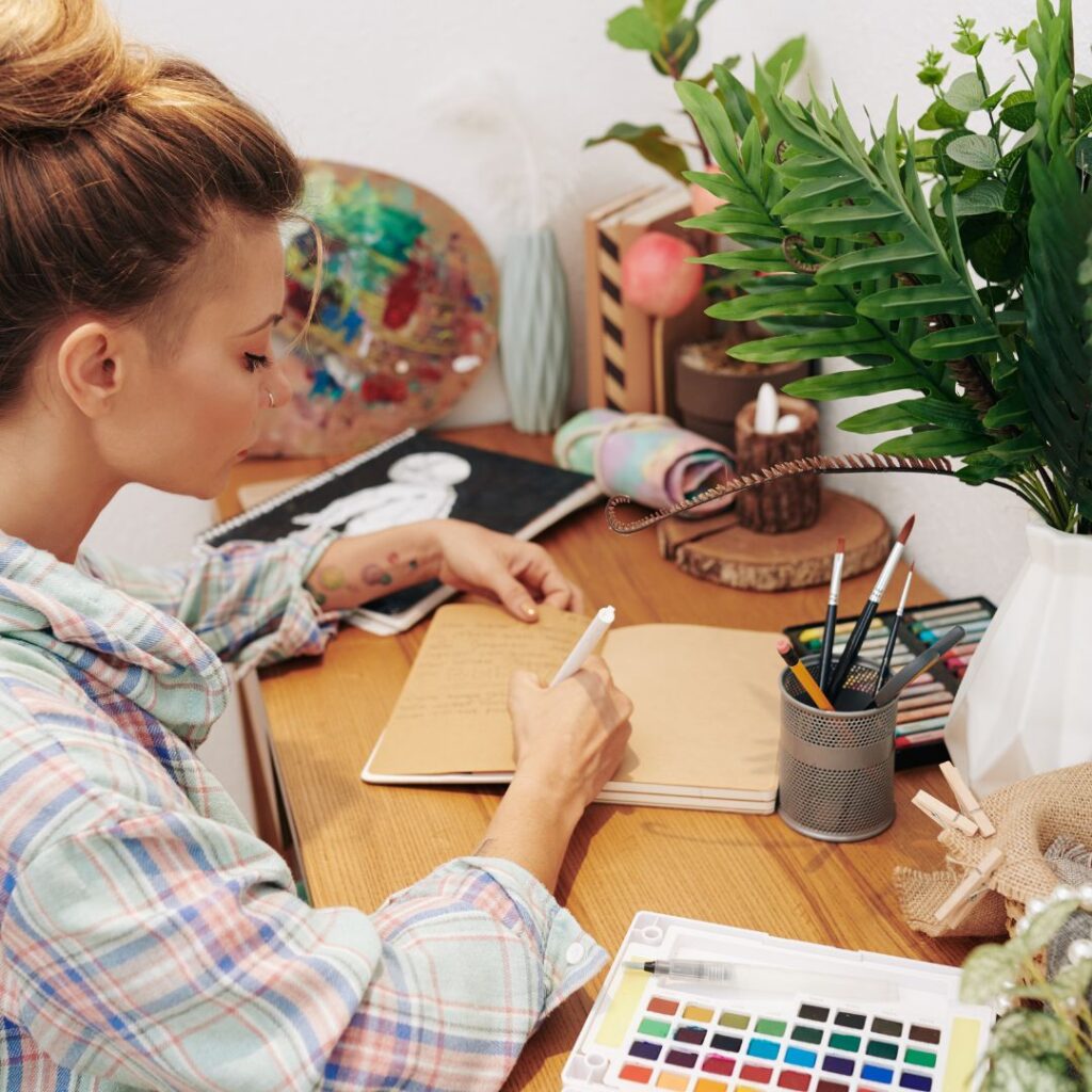 Girl at desk with journal and colour palette