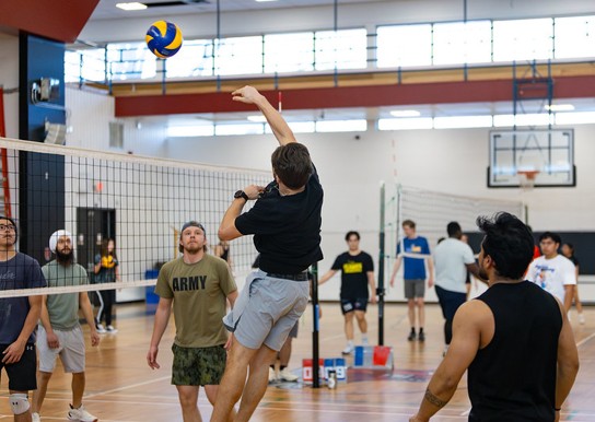 A group of students playing volleyball in the South Gym.