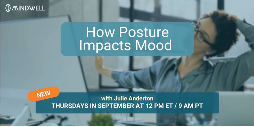 woman stretching her neck at her desk