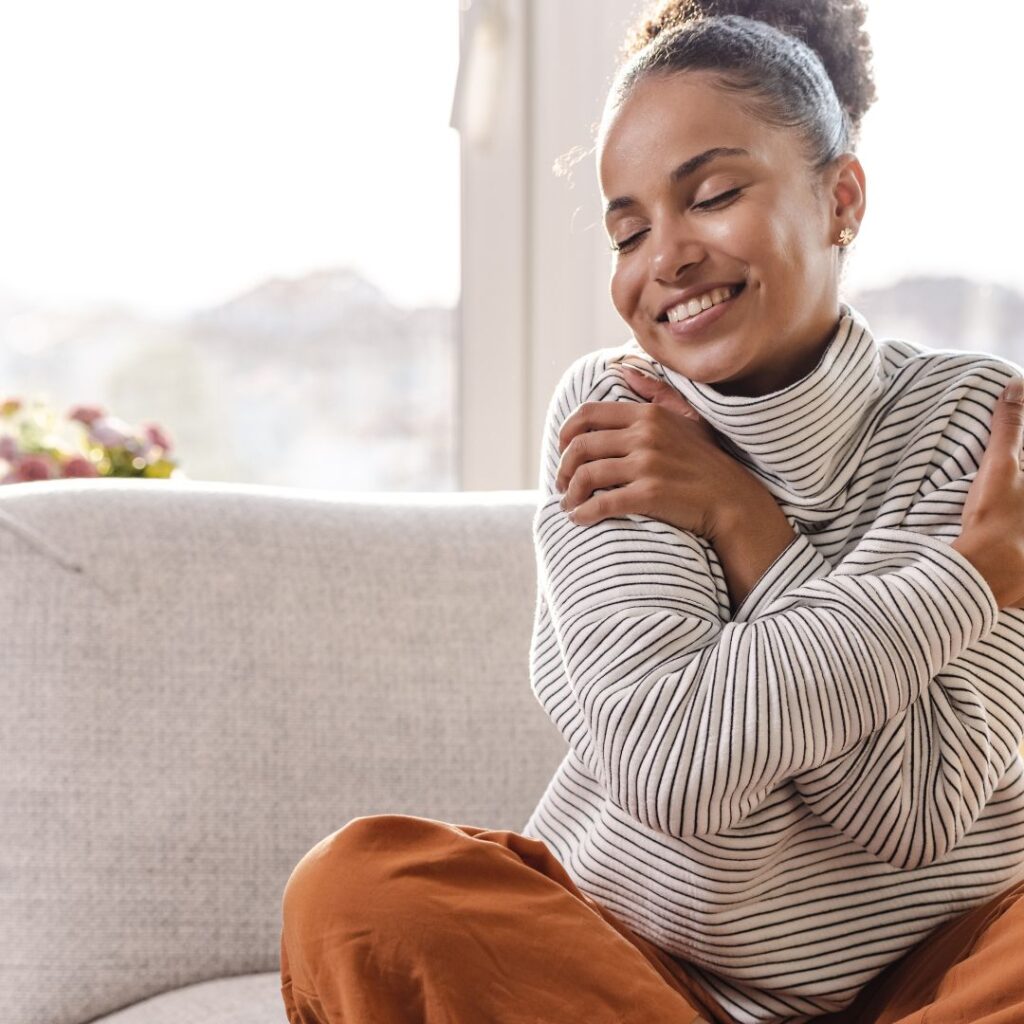 A woman hugging herself.