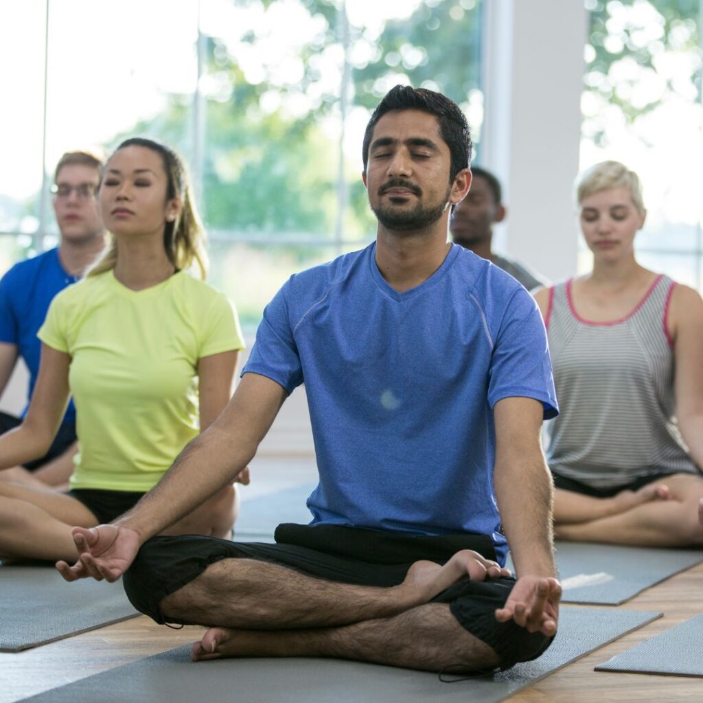 Group doing a seated position in yoga class