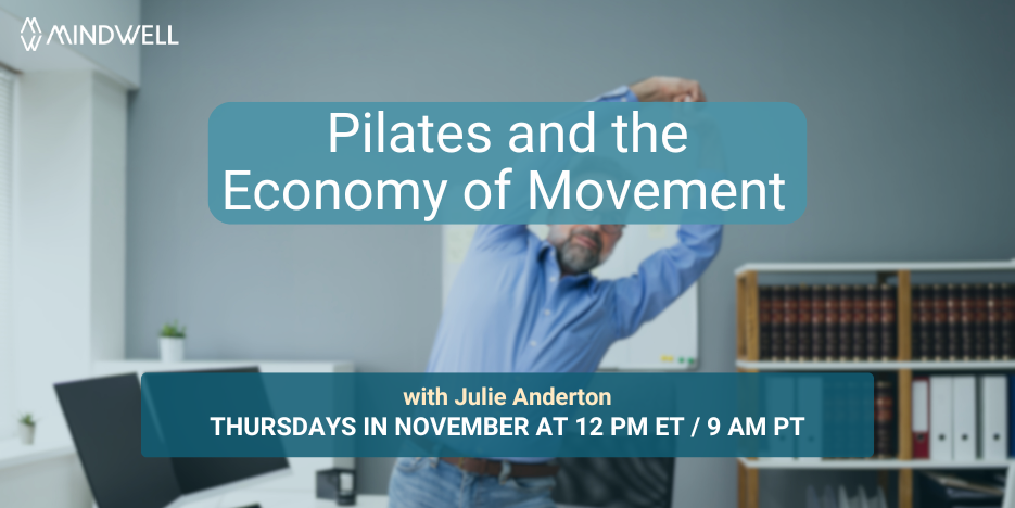 man stretching both arms above his head in front of desk