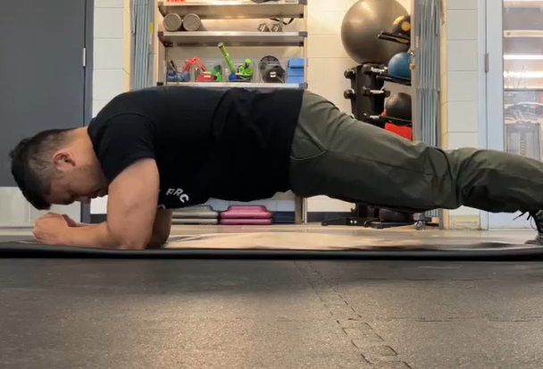 Henry demonstrating a forearm plank.