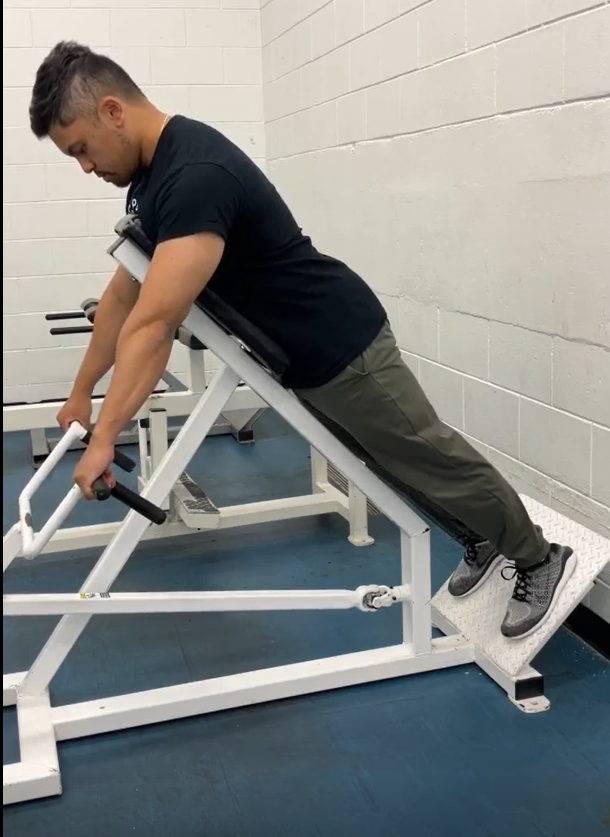 Picture of a person on the chest supported row, back is straight, feet are set and arms are straight in the starting position