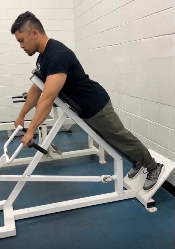 Picture of a person on the chest supported row, back is straight, feet are set and arms are straight