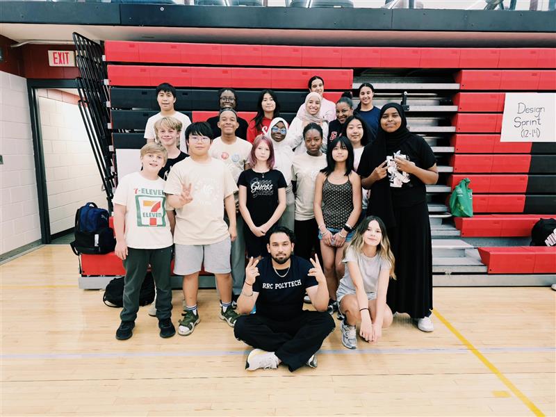 A group of campers are smiling at the camera with three camp leaders join the photo