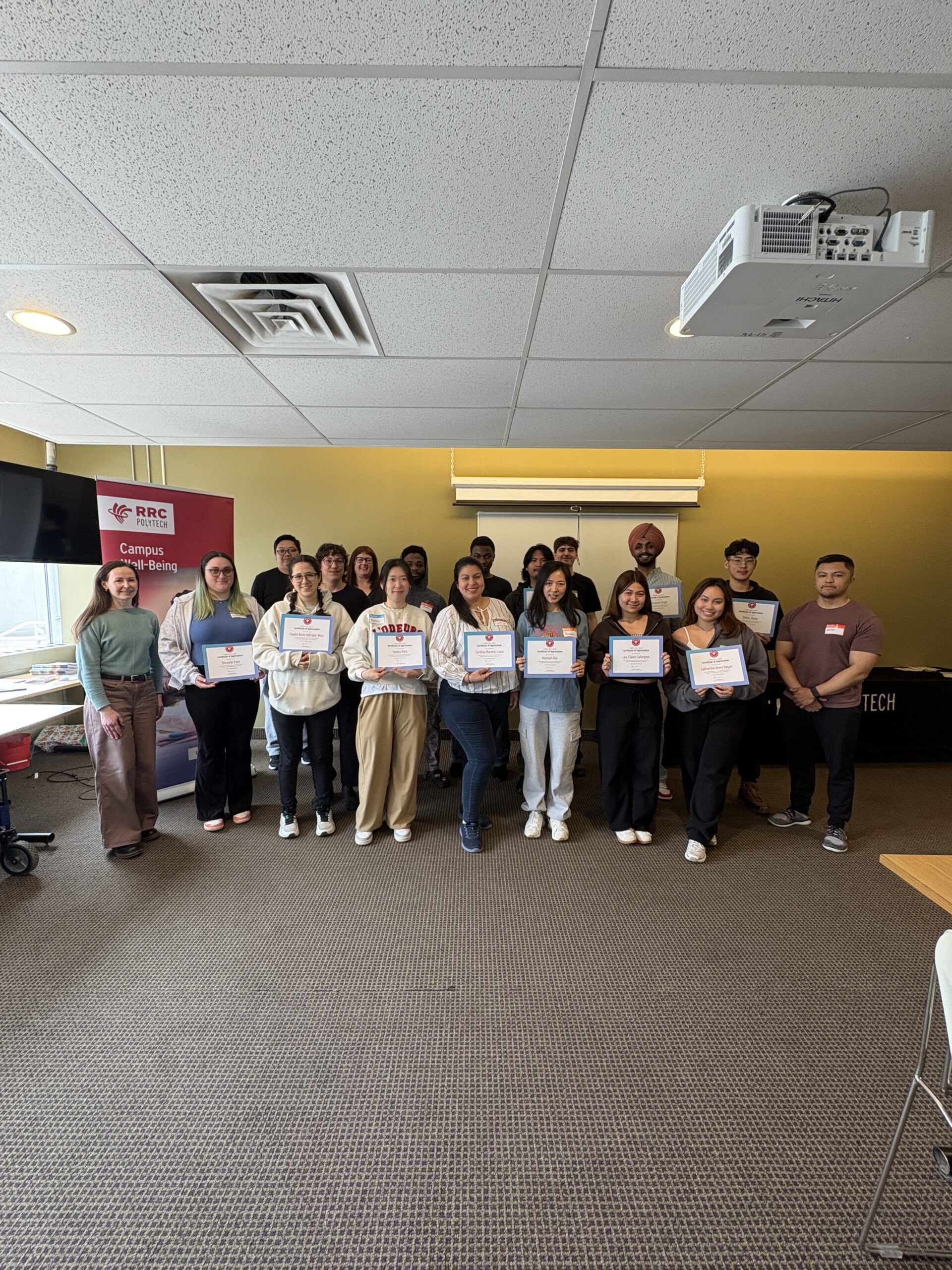A group of student volunteers holding their certificates.