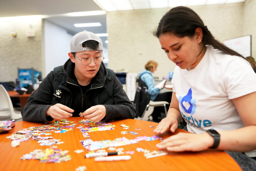 Two students doing a puzzle.