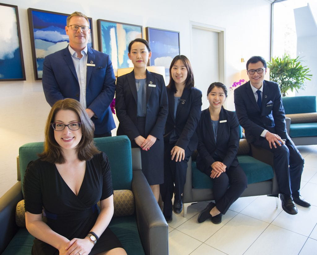 Group of smiling people in the Delta Hotel