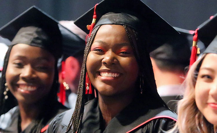 Smiling woman in grad cap and gown