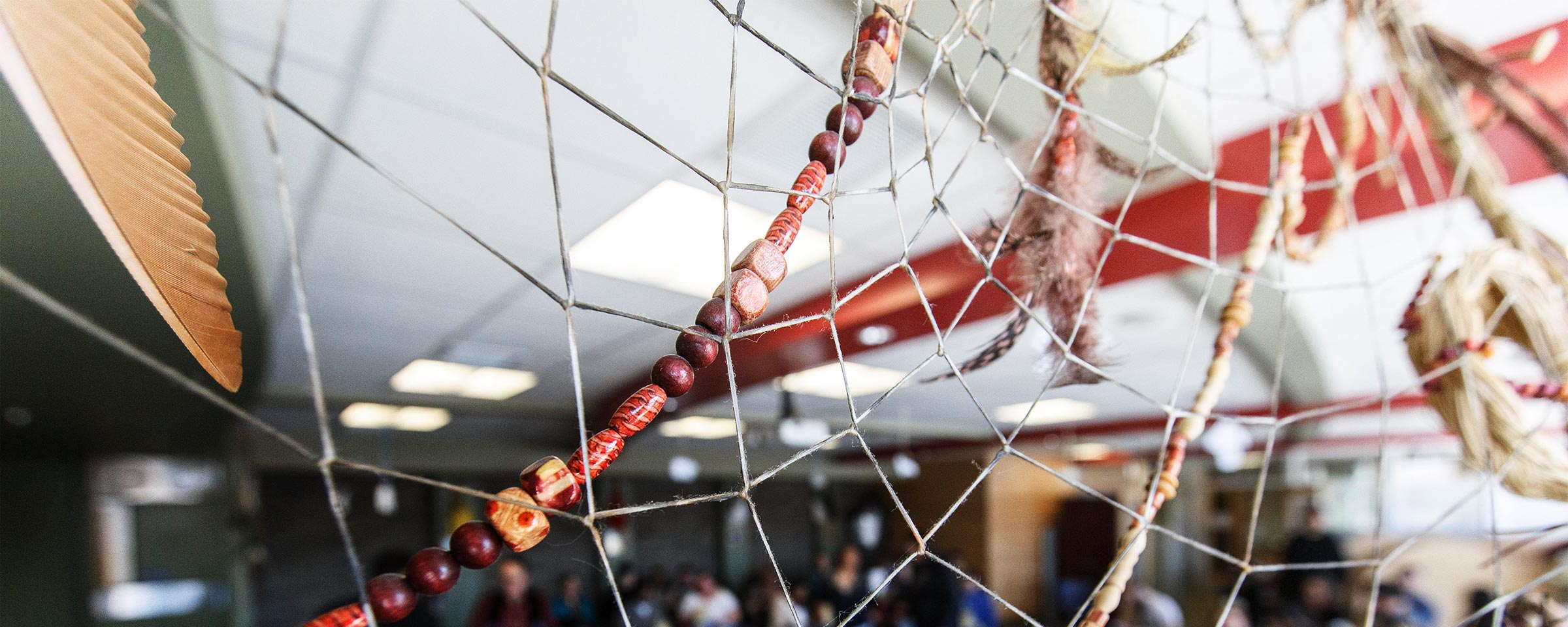 Shot of Indigenous Support Centre, taken through a dreamcatcher