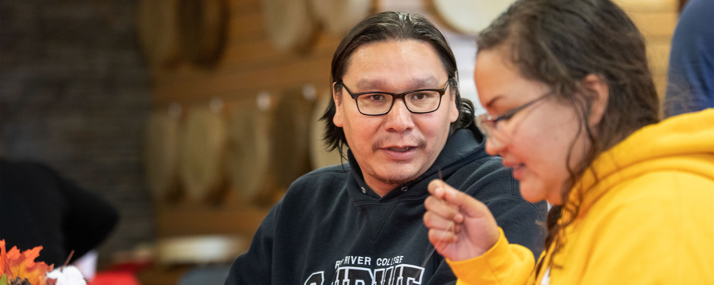 Male and female Indigenous students, conversing