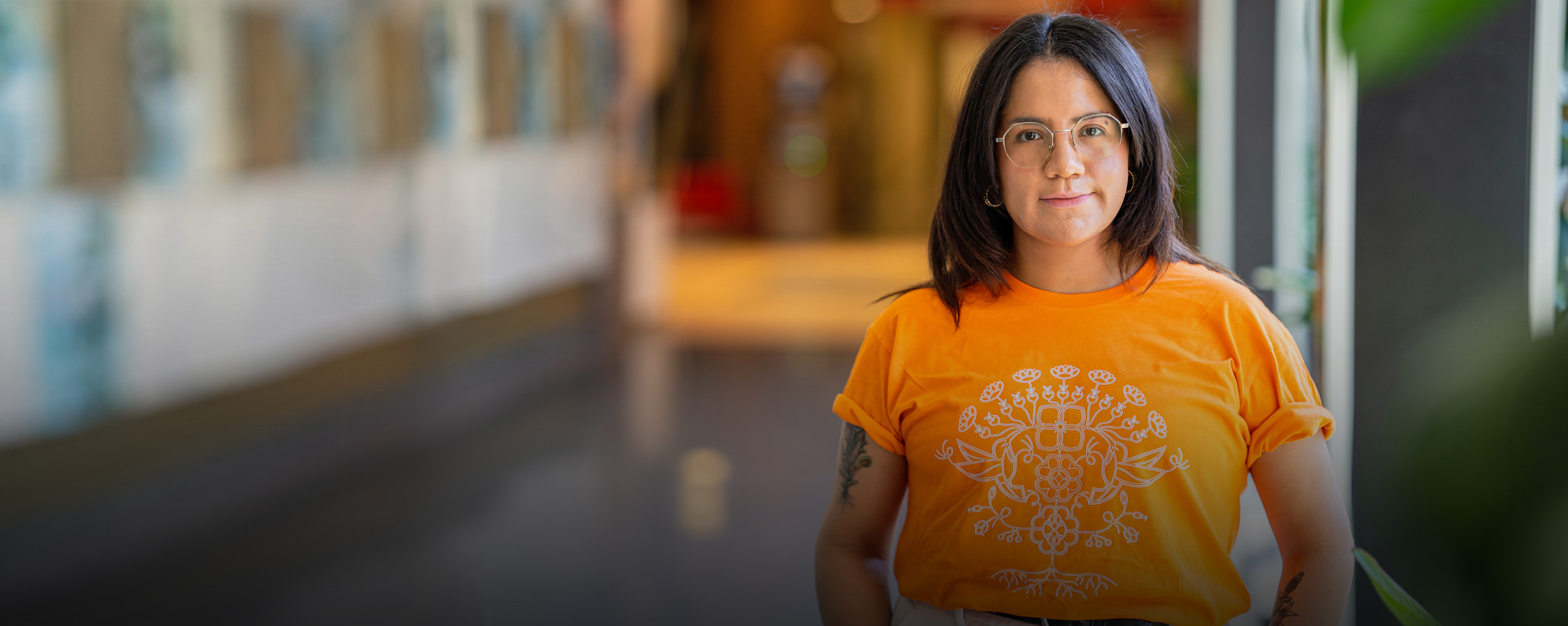 RRC Polytech grad Leticia Spence, wearing shirt created for Orange Shirt Day.