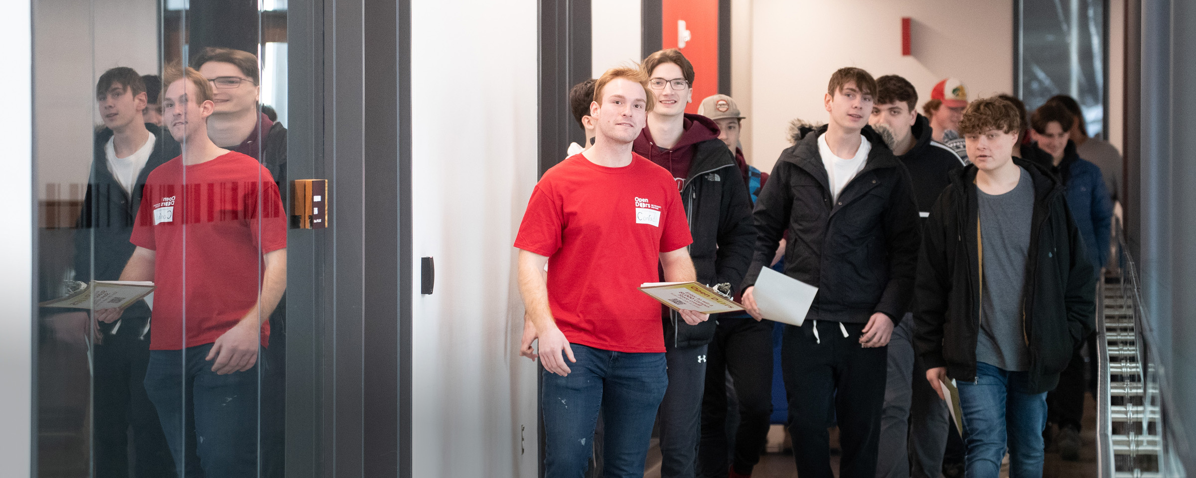 Male student leading prospective students on a tour during RRC Polytech's Open Doors event.