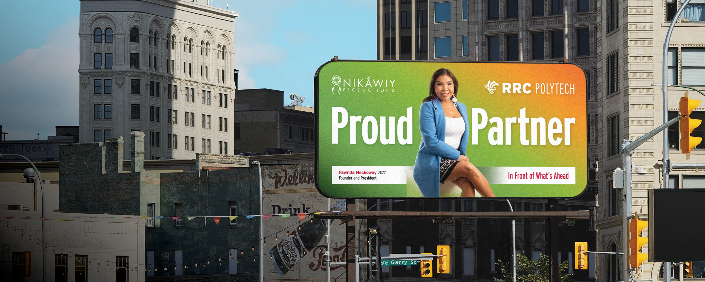 Winnipeg skyline with "Proud Partner" billboard of RRC Polytech graduate Fawnda Neckoway.