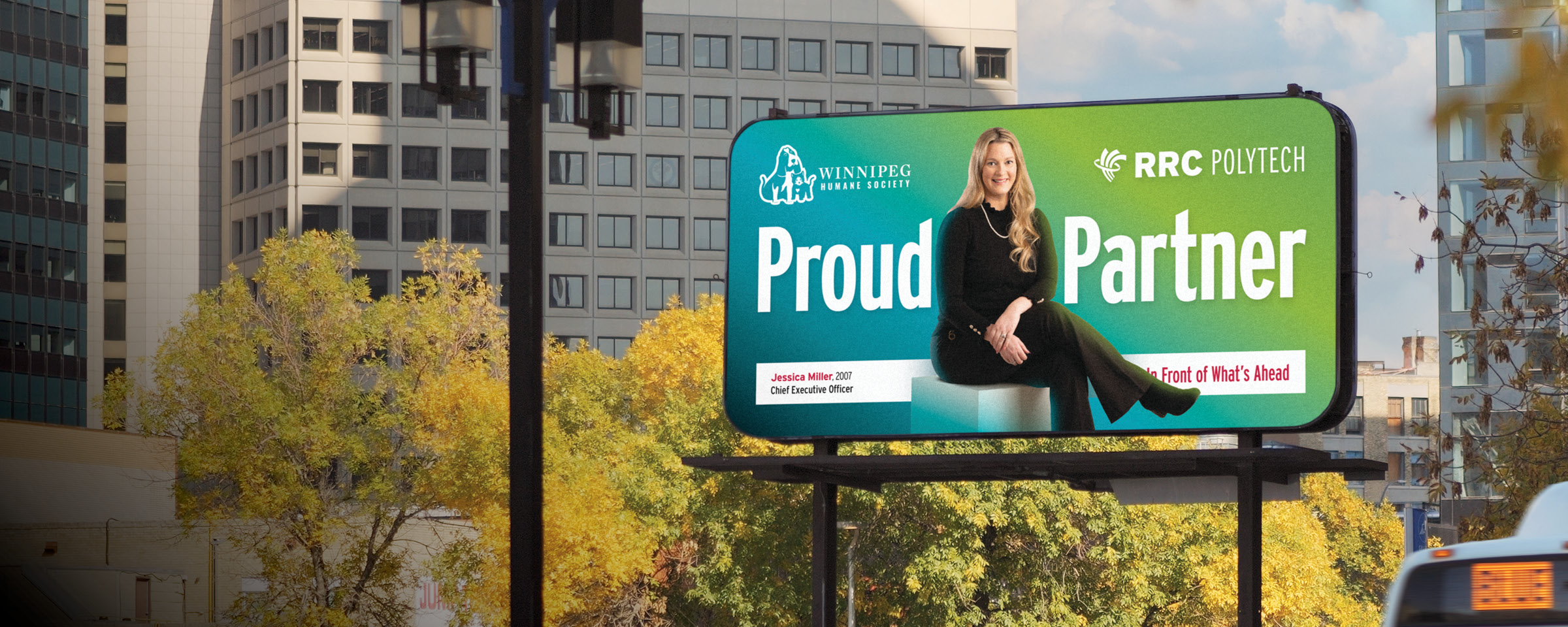 Winnipeg skyline with "Proud Partner" billboard of RRC Polytech graduate Jessica Miller.