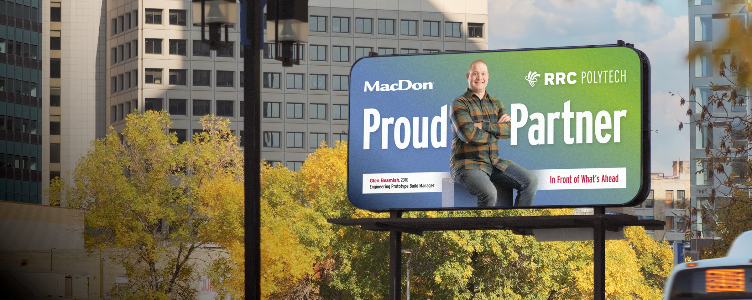 Winnipeg skyline with "Proud Partner" billboard of RRC Polytech graduate Glen Beamish.