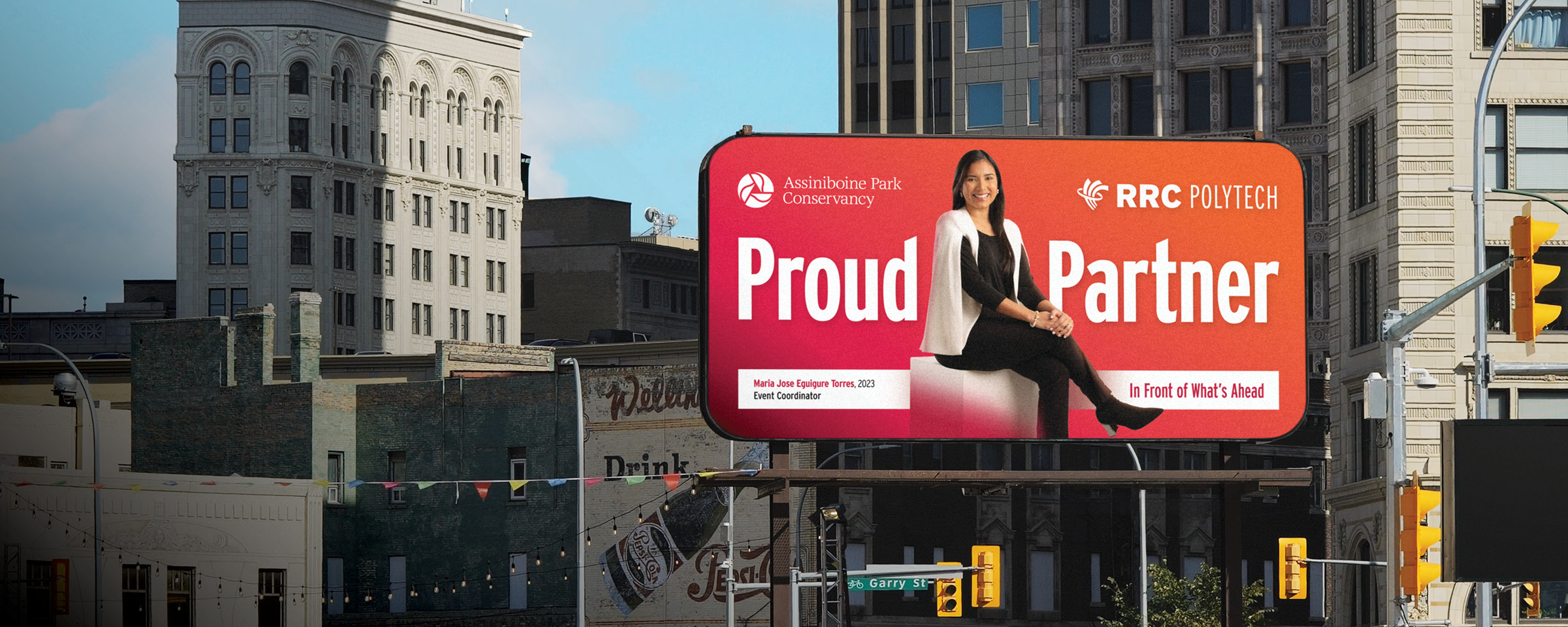 Winnipeg skyline with "Proud Partner" billboard of RRC Polytech graduate Maria Jose Eguigure Torres.