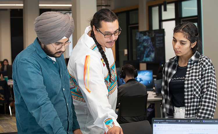 Three students collaborating at a table