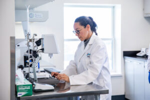 Woman in lab coat conducting experiment