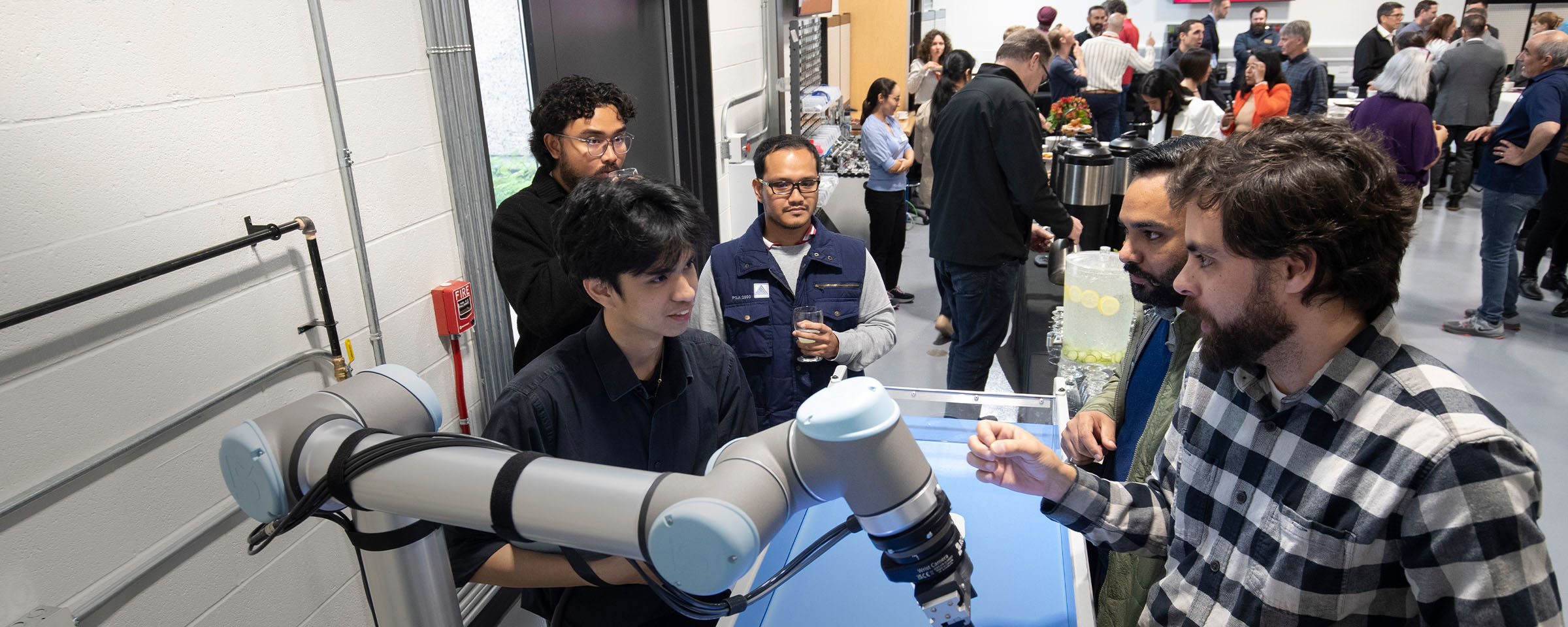 Male researcher demonstrates use of manufacturing equipment.