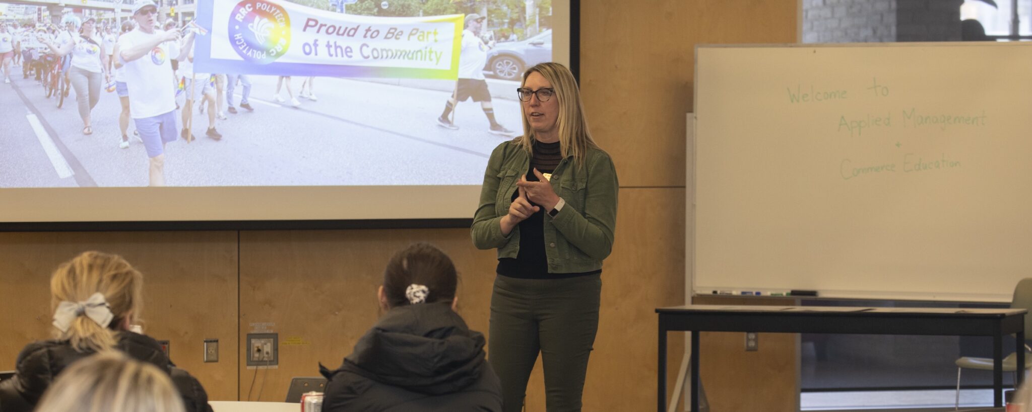 Female instructor making presentation to classroom.