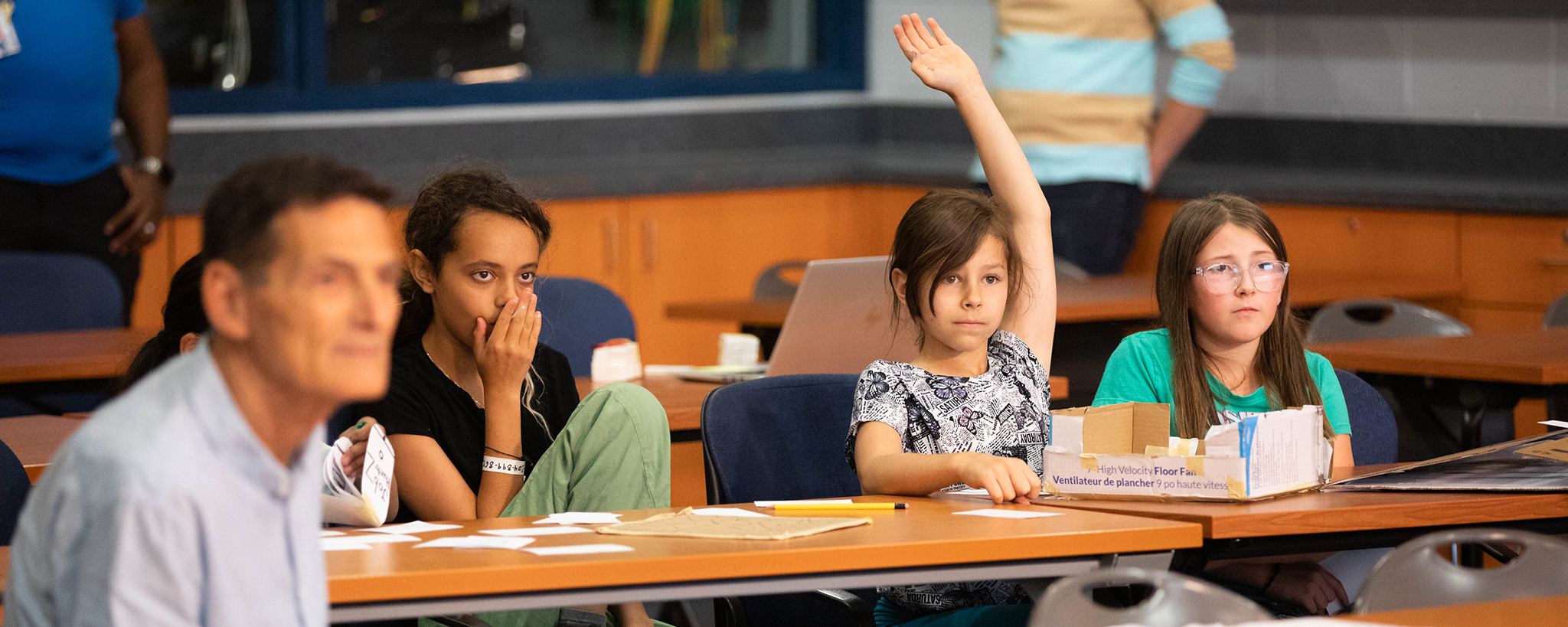 student raising hand in class